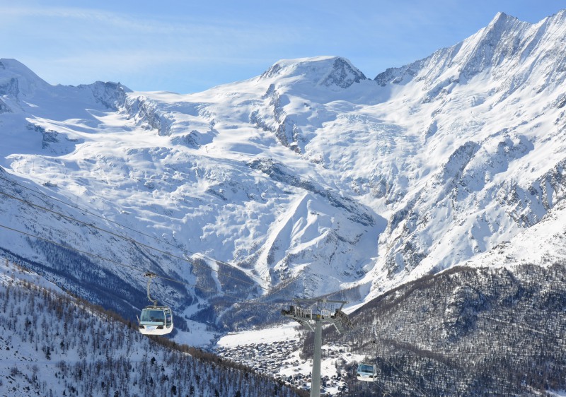 Image of the Saas Fee ski resort in Switzerland's Valais, Lemanic Region. A chalet and ski lift are prominent, surrounded by pristine snow and a stunning winter scenery.