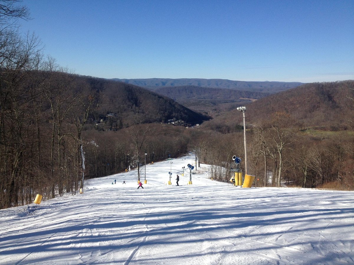 The Homestead Resort in USA - a ski slope with people skiing down it.
