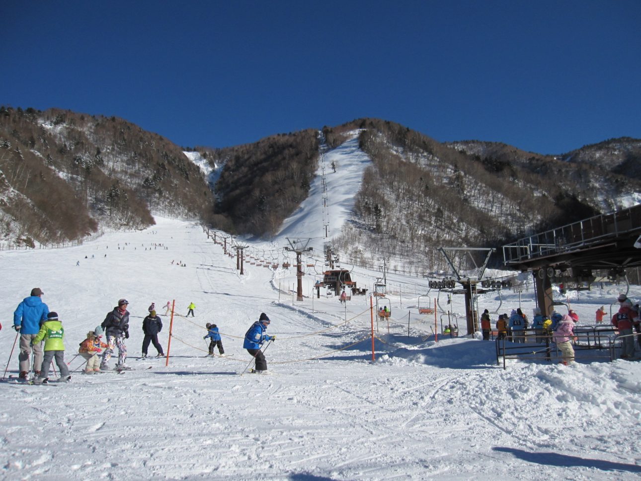 Hirayu Onsen in Japan - a group of people skiing down a snowy slope.