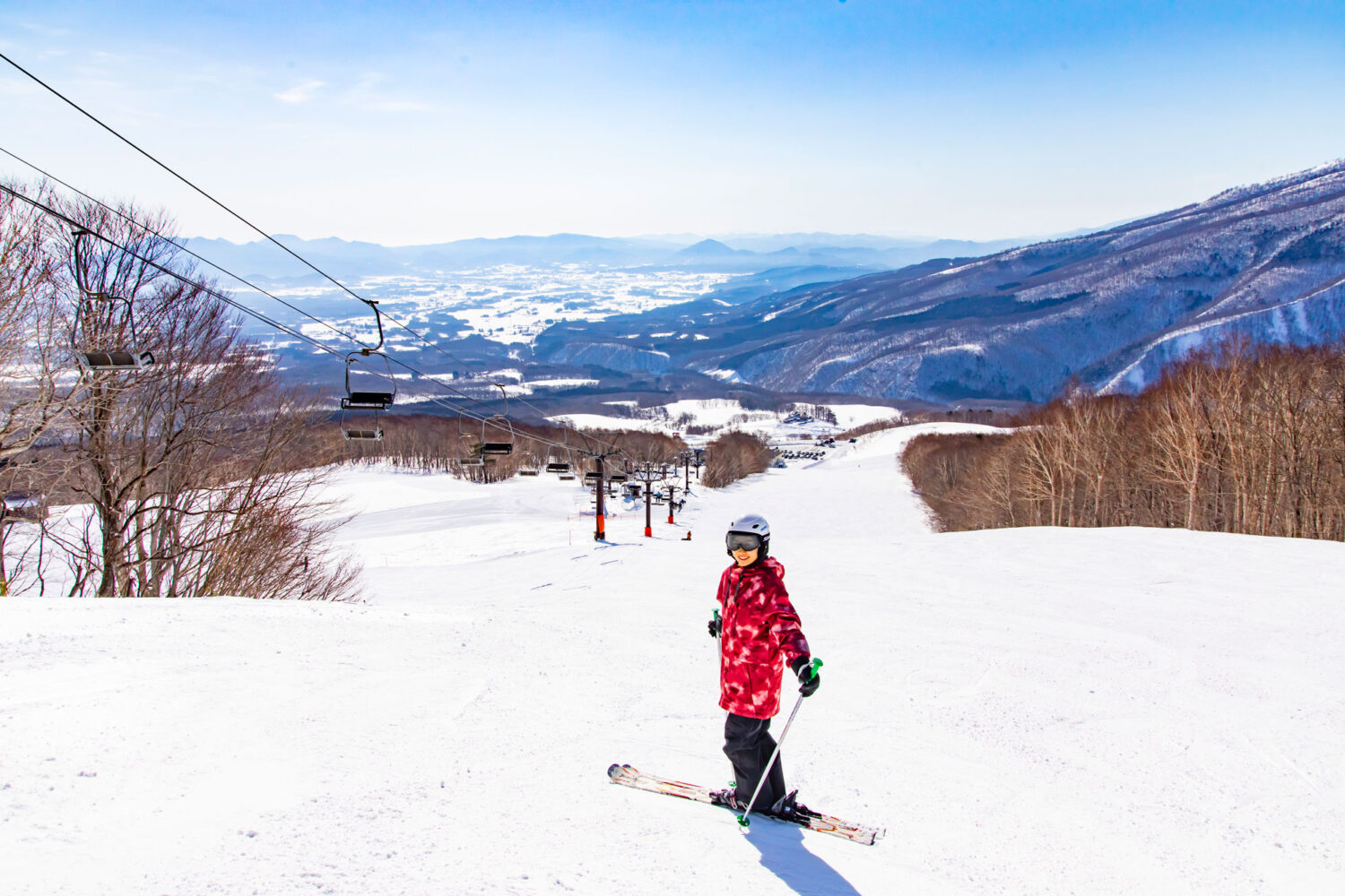 Amihari Onsen in Japan - a person riding a snowboard down a snowy slope.
