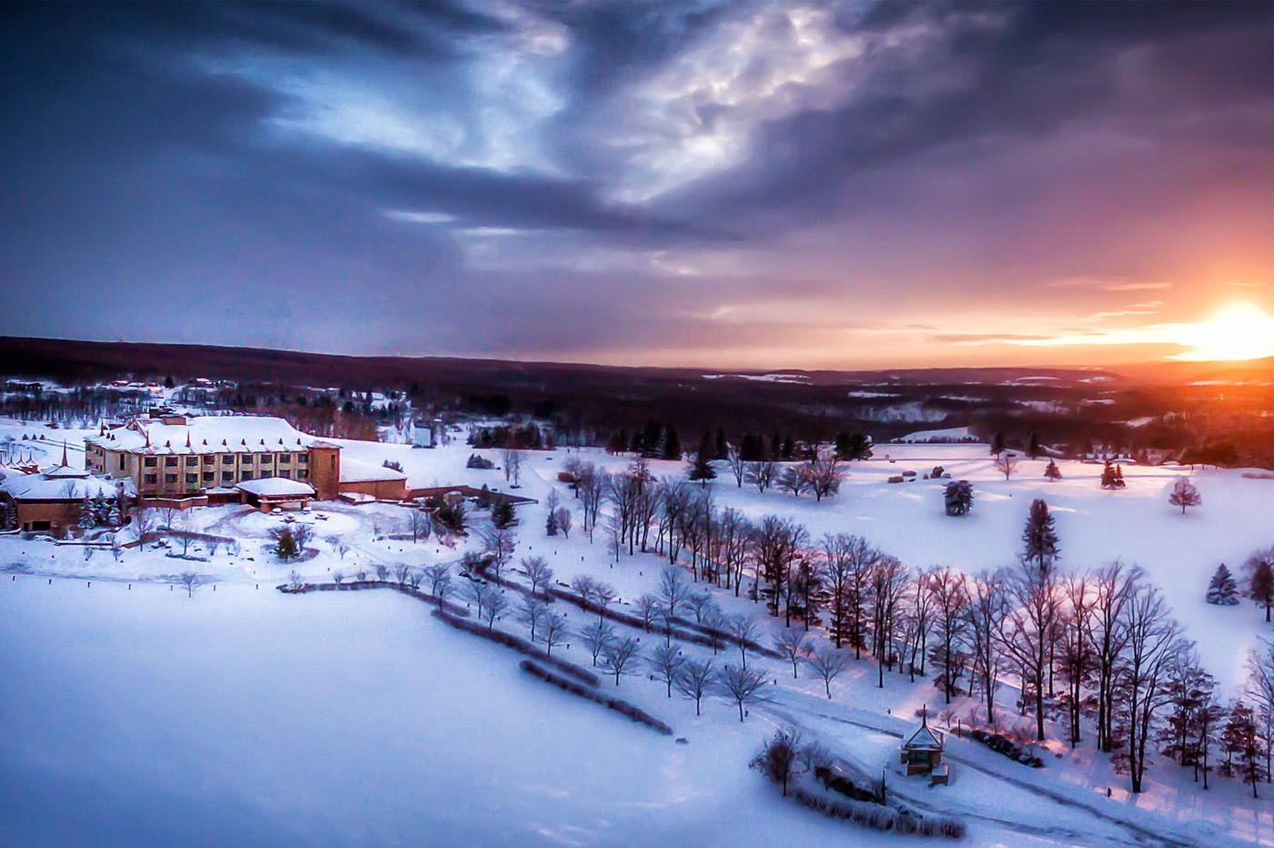 Winter scene at Mystic Mountain – Farmington, Pennsylvania, depicting a picturesque snowy landscape, vibrant winter sports scene, and a quaint ski resort with a chalet in the distance.
