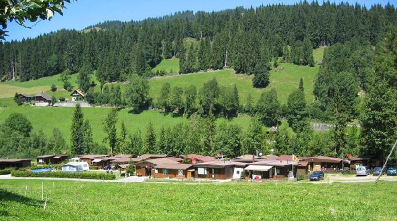 Bumbach in Switzerland - a green hillside with houses in the background.