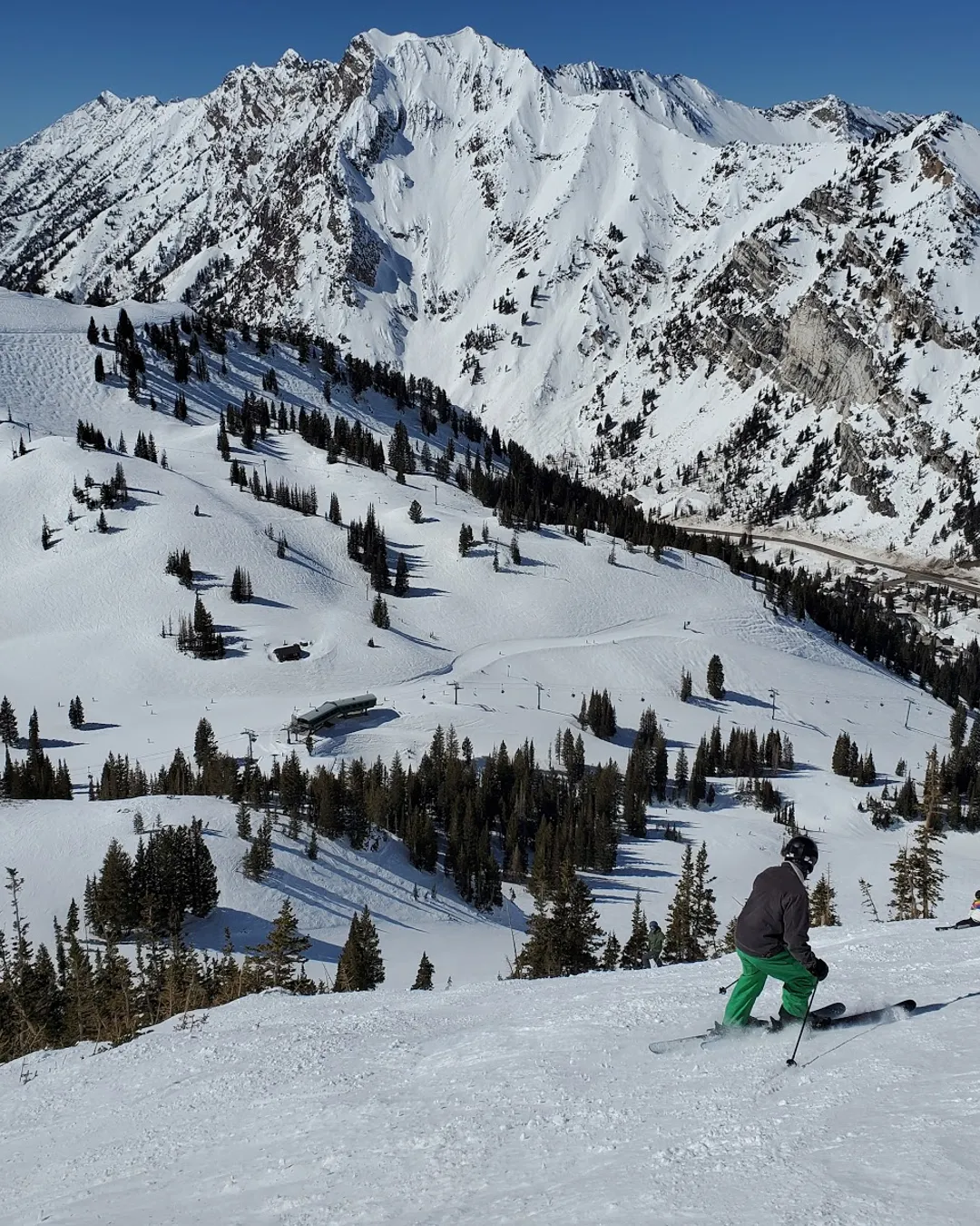 Alta in USA - a person skiing down a snow covered mountain.