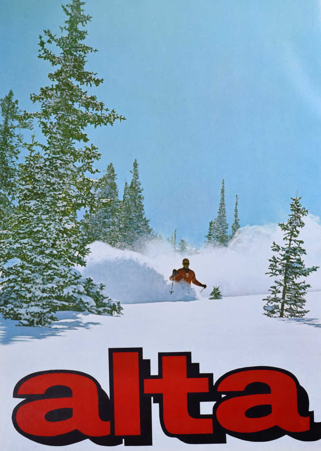 Alta in USA - a man riding a snowboard down a snow covered slope.