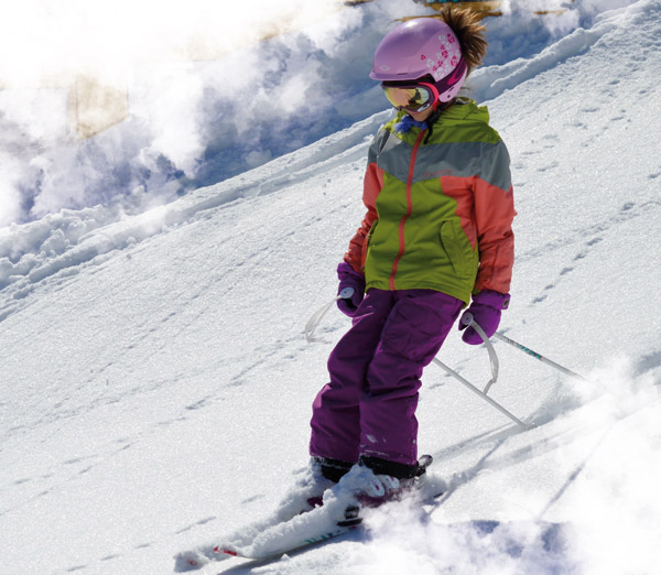 Mont Biencourt in Canada - a young girl skiing down a snowy slope.