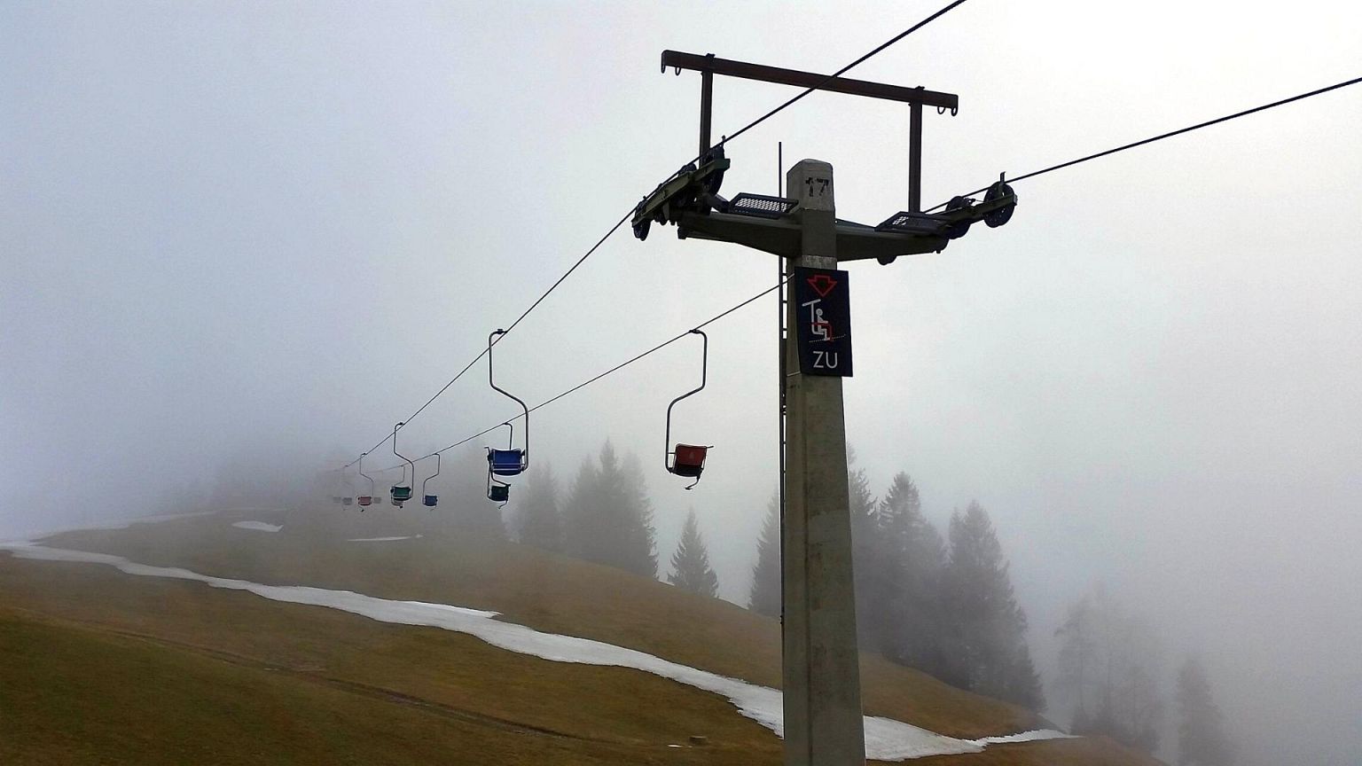 Schnepfenried in France - a ski lift going up a hill in the fog.