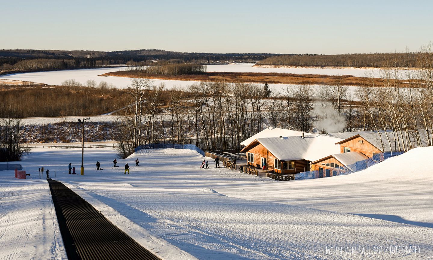 Wapiti Valley in Canada - a snow covered ski slope with a small cabin in the background.