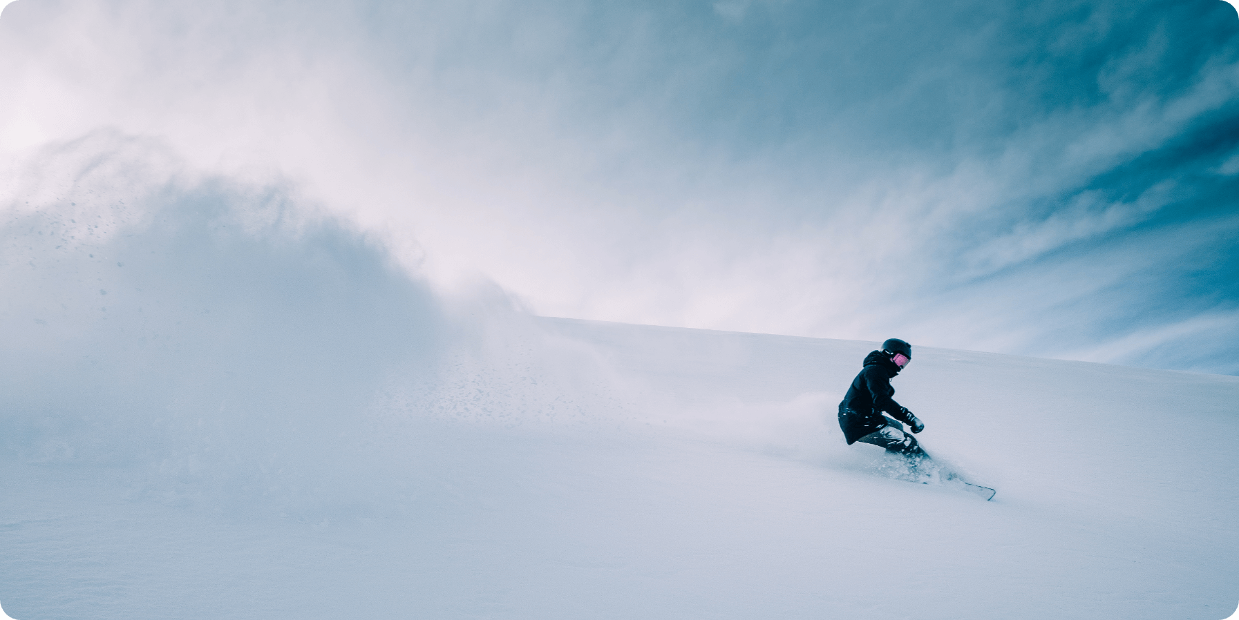 A skier enjoying a winter sports scene at Cerler in Aragon Huesca Spain. The background features a chalet nestled among snow-covered slopes. Snowboarders and a snowmobile can be spotted in the distance.