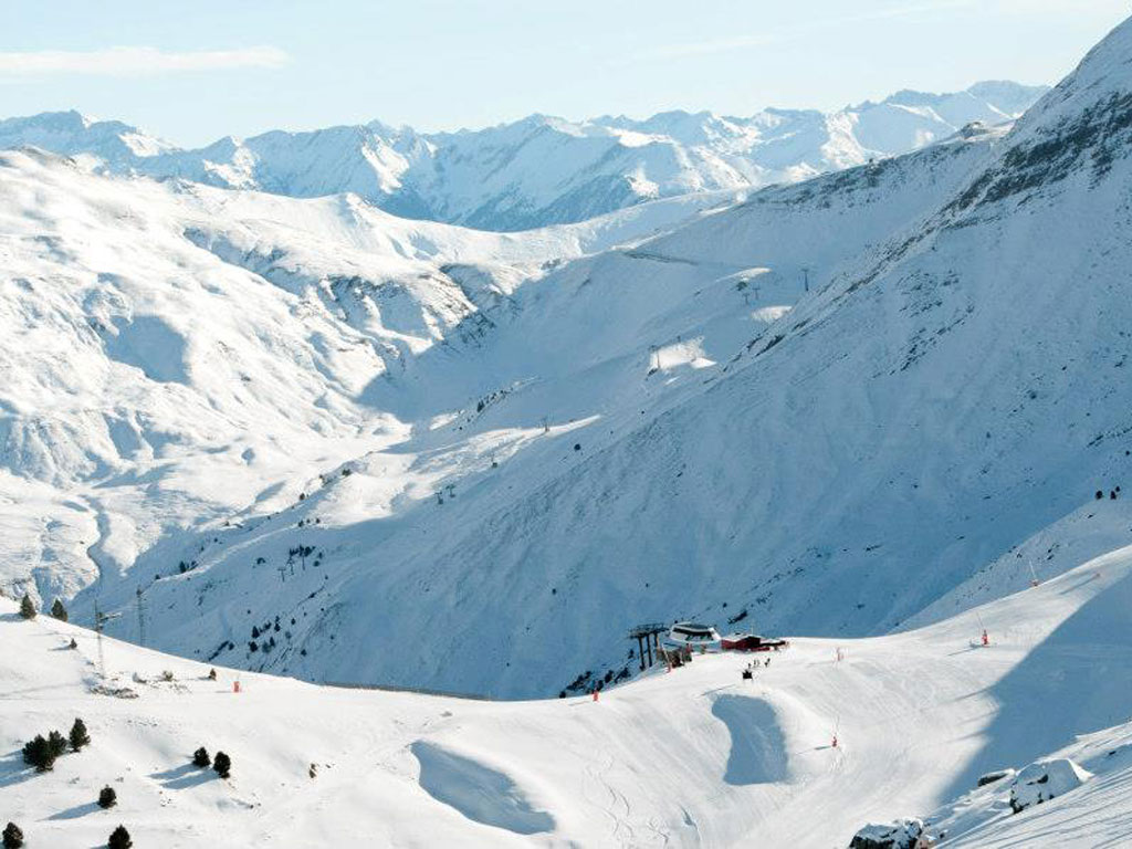 Cerler in Spain - a group of people skiing down a snow covered mountain.