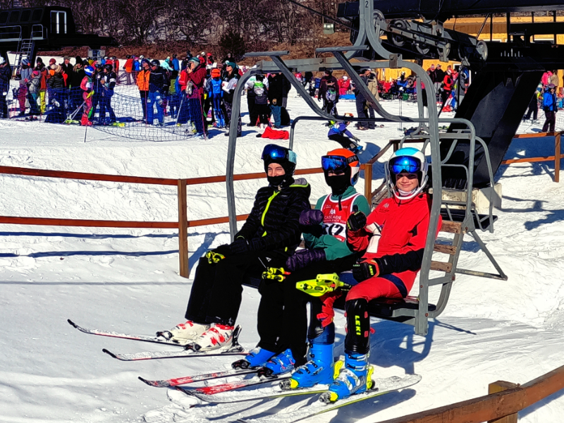 Tyrol Basin – Mt Horeb in USA - a group of people sitting on a ski lift.