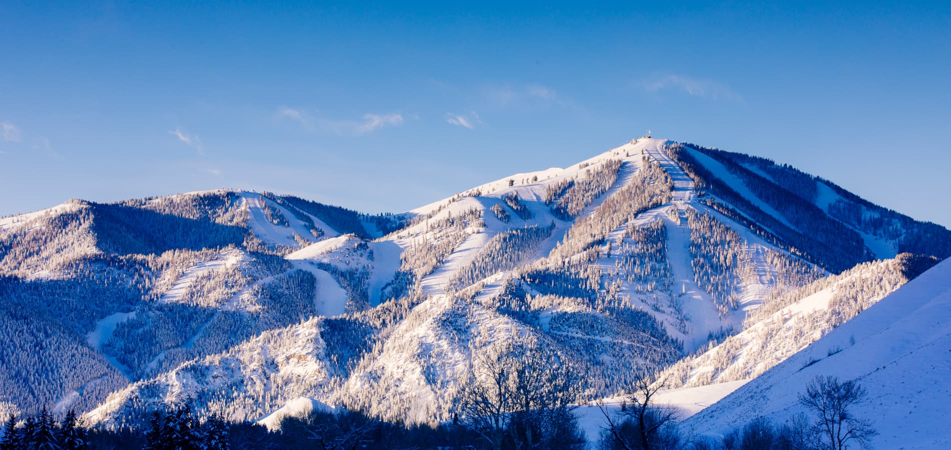 View of Bald Mountain in Idaho featuring a ski resort brimming with winter sports activities surrounded by a stunning winter landscape with snow covered peaks.