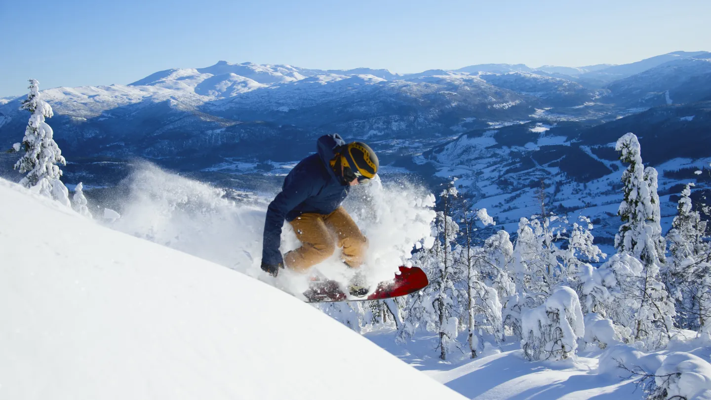 Voss Resort in Norway - a person on a snowboard in the mountains.