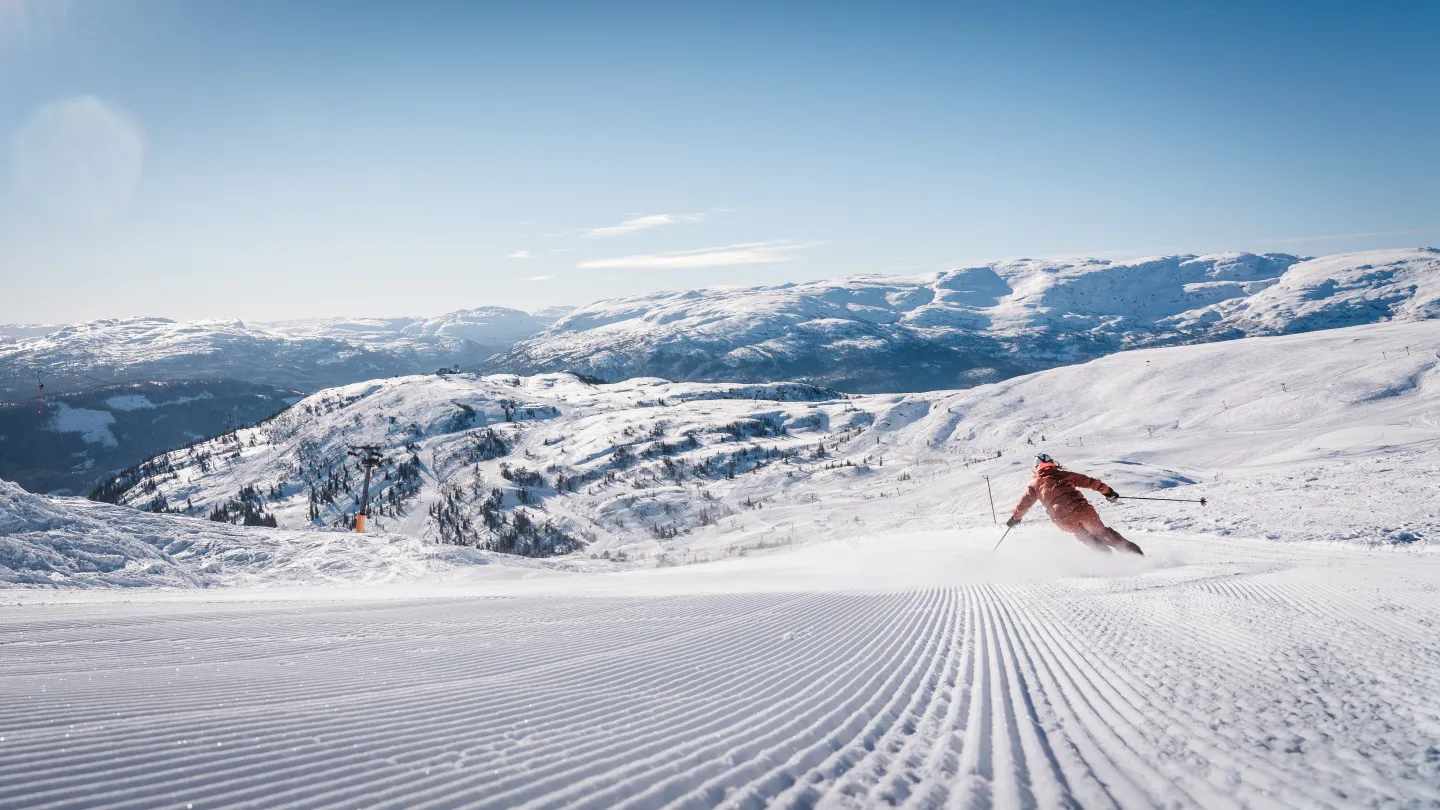 Voss Resort in Norway - a person skiing down a snow covered mountain.