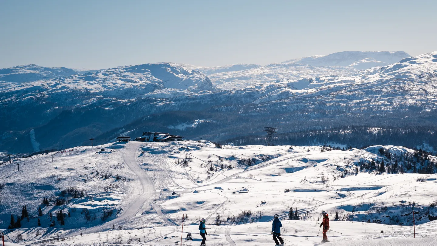 Voss Resort in Norway - a group of people skiing down a snowy slope.