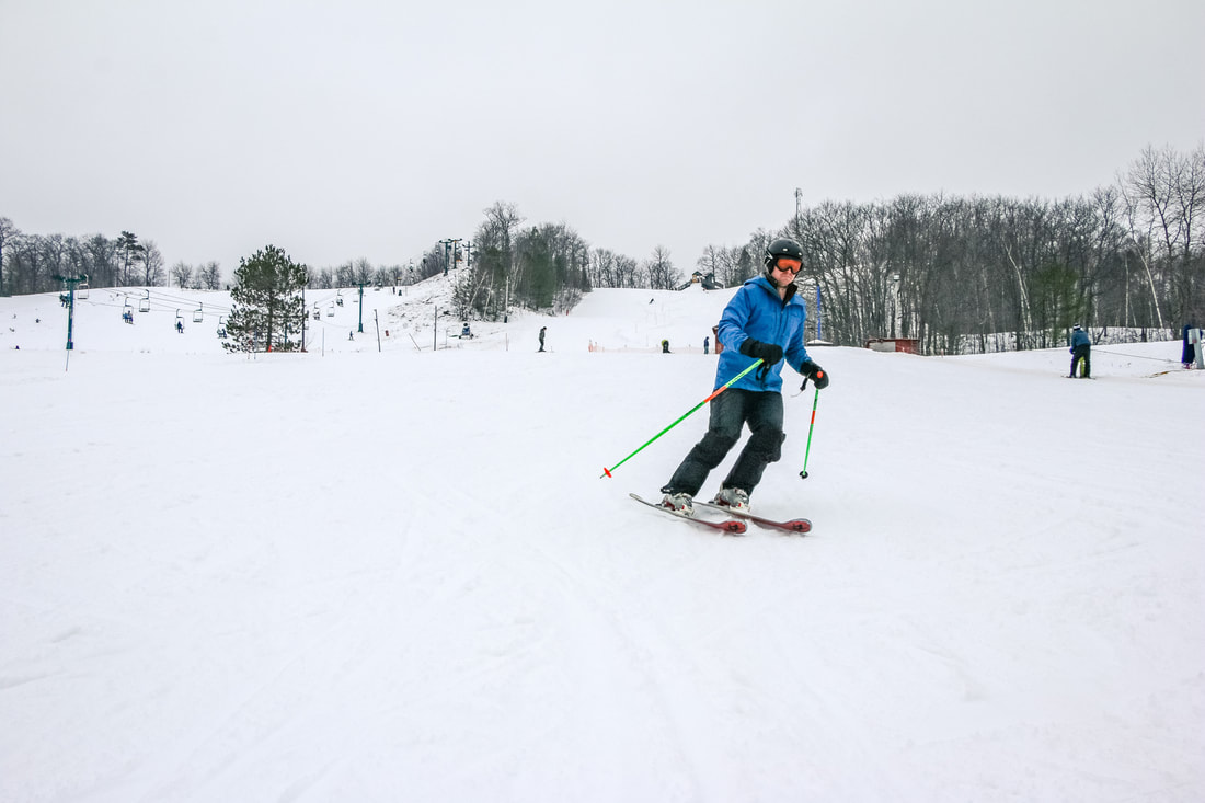 Mt Ashwabay – Salmo in USA - a man riding skis down a snow covered slope.