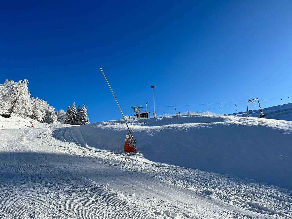 Matthias-Schmidt-Berg – St Andreasberg in Germany - a person riding a snowboard down a snow covered slope.