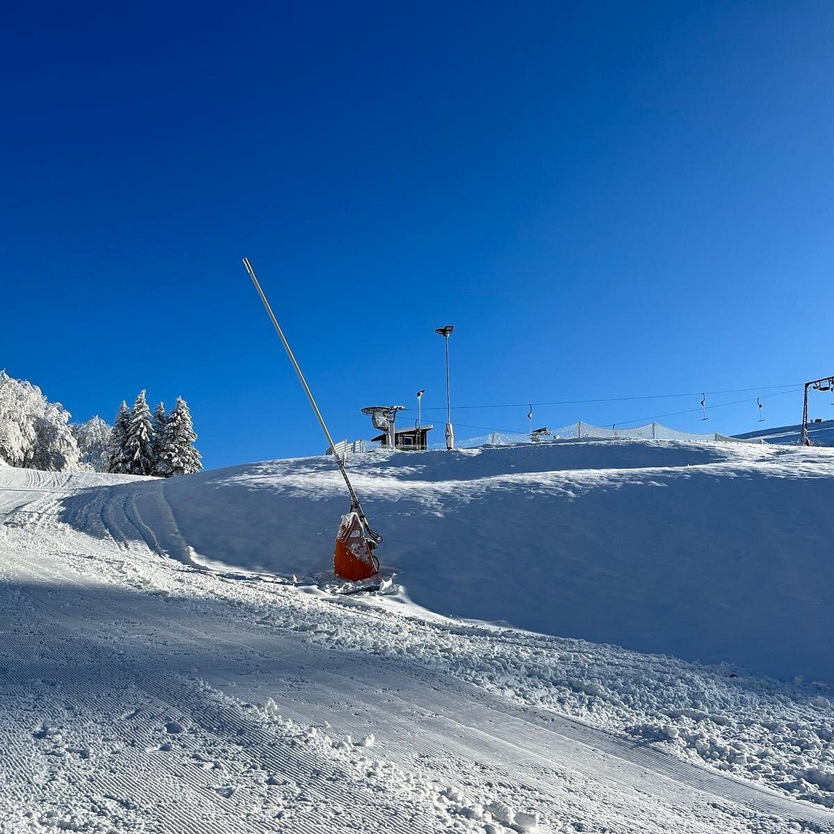 Matthias-Schmidt-Berg – St Andreasberg in Germany - a man riding a snowboard down a snow covered slope.