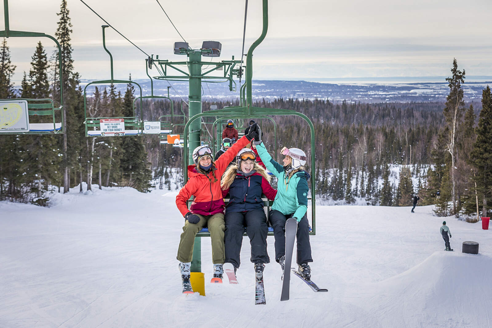 Hilltop – Anchorage in USA - a group of people riding a ski lift.