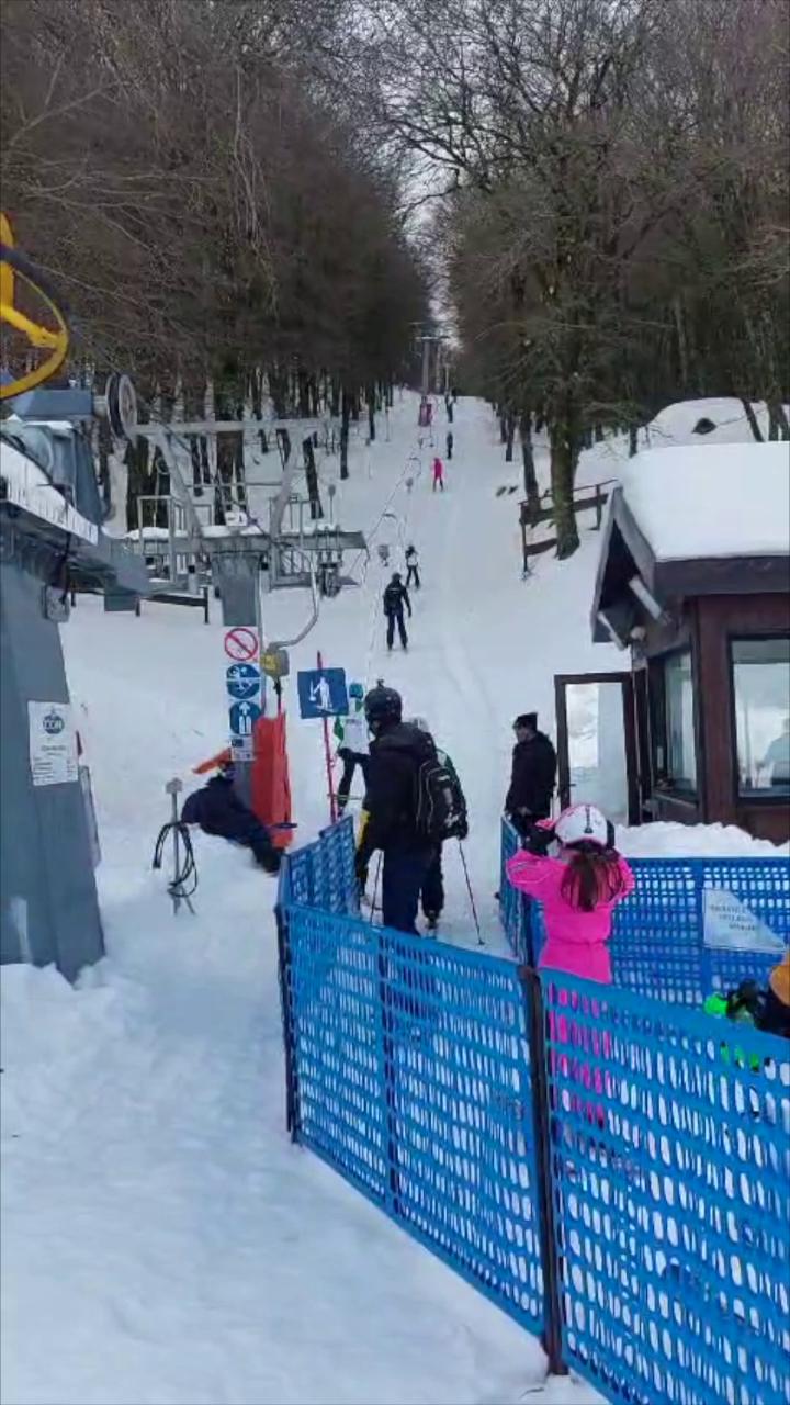 Impianti di risalita Piano Battaglia in Italy - a group of people riding down a snow covered slope.
