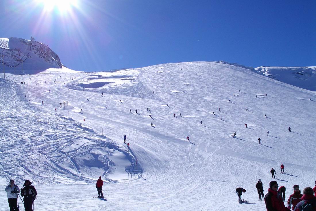 Hintertux Glacier in Austria - a group of people skiing down a mountain.