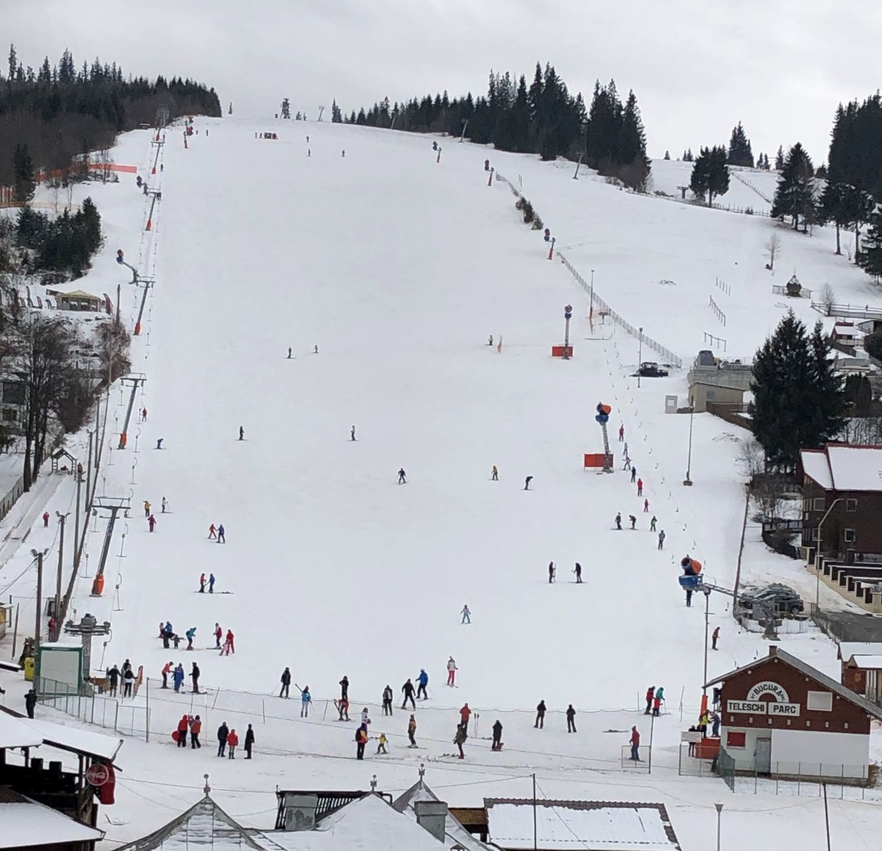 Vatra Dornei in Romania - a ski slope with people skiing down it.