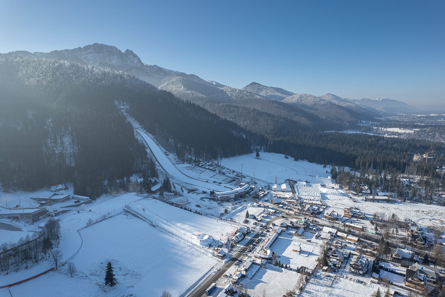 Witów in Poland - an aerial view of a snowy village in the austrian alps.