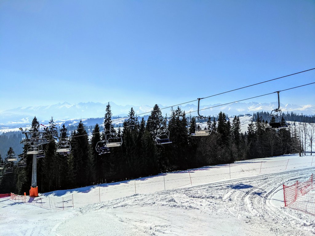 Witów in Poland - a snow covered ski slope with trees in the background.