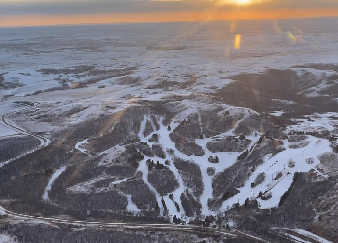 Huff Hills in USA - an aerial shot of the sun setting over the mountains.