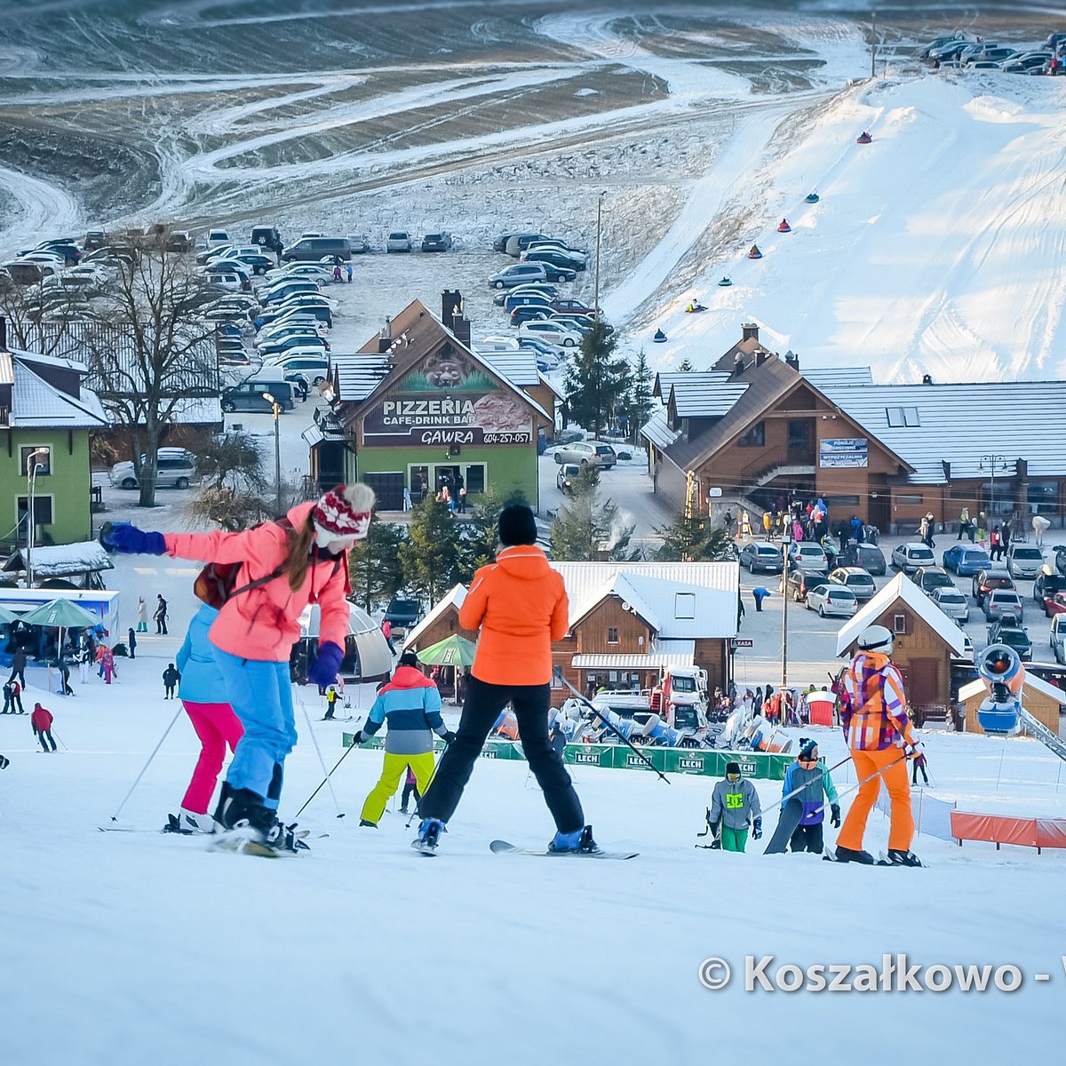 Tylicz in Poland - a group of people skiing down a hill.