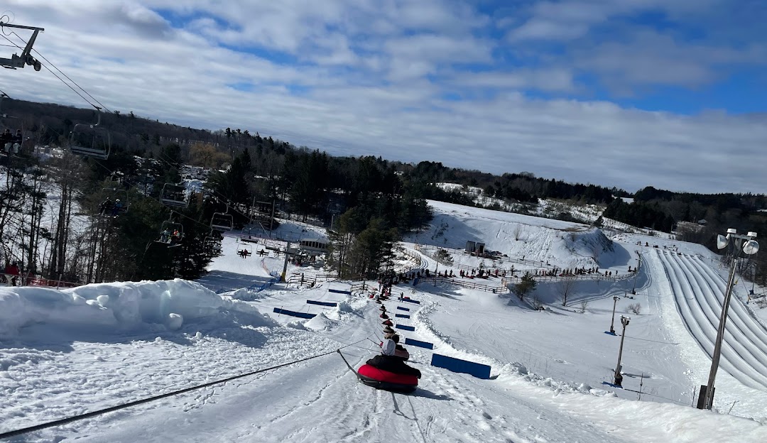 Winter scene at Lakeridge Resort in Southern Ontario, Canada, featuring a skier gliding down a snow-covered slope amid a stunning, frosty landscape.