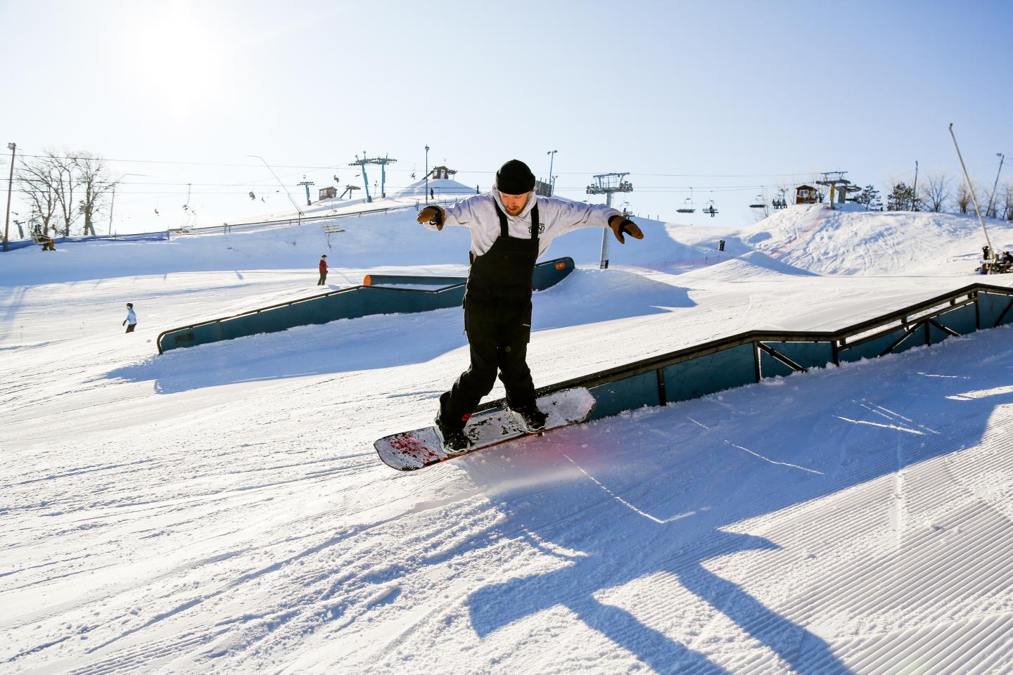Powder Ridge in USA - a man riding a snowboard down a snow covered slope.