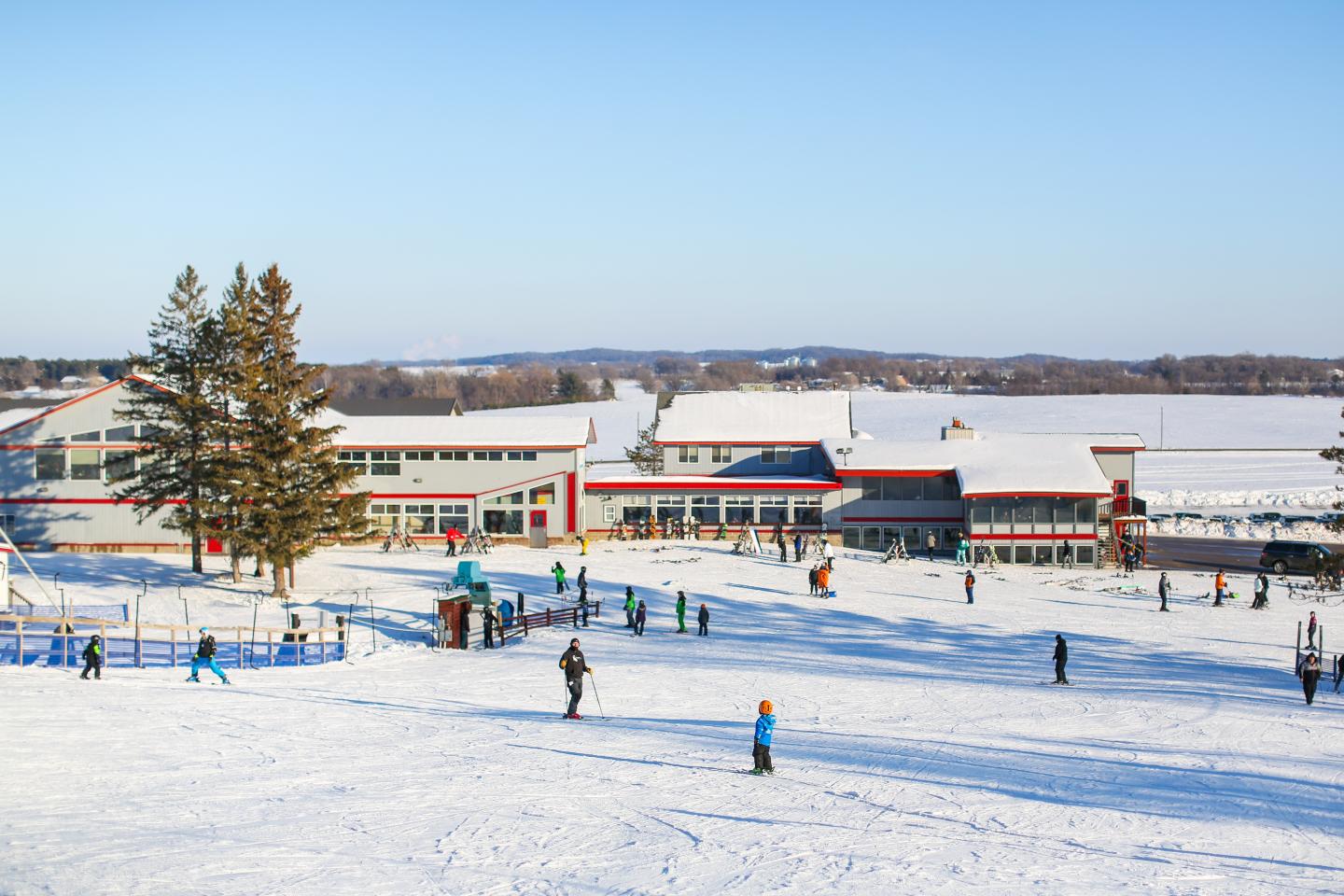 Powder Ridge in USA - a group of people skiing on a snow covered field.
