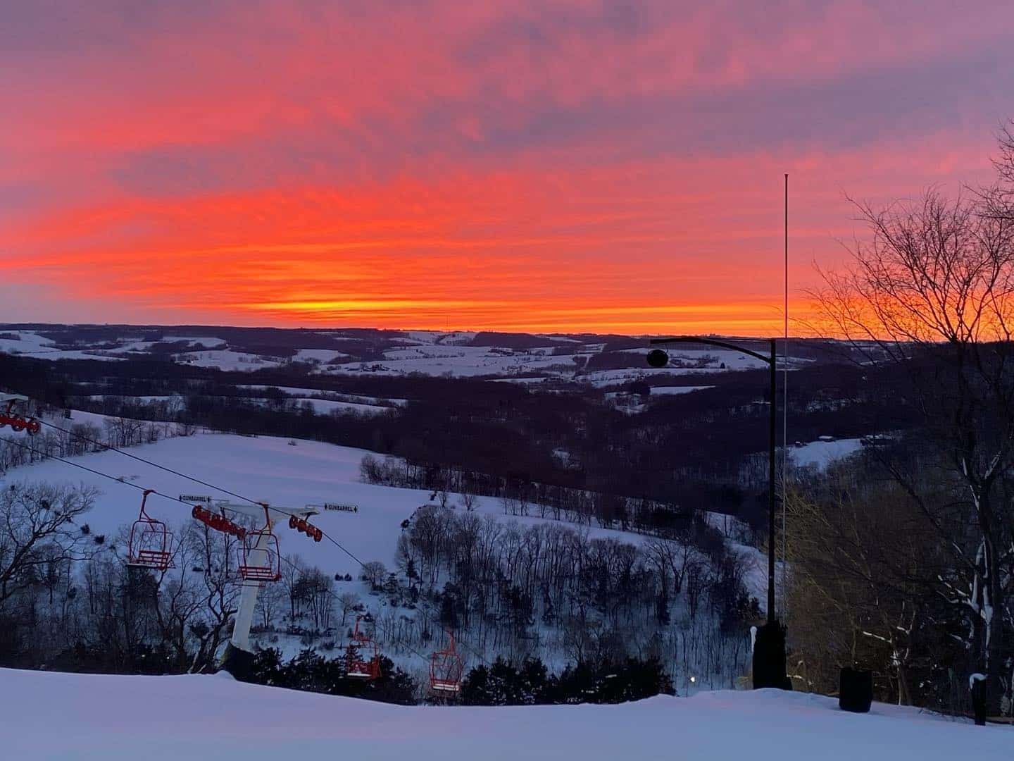 Sundown Mountain Resort in USA - a ski lift going up a hill at sunset.