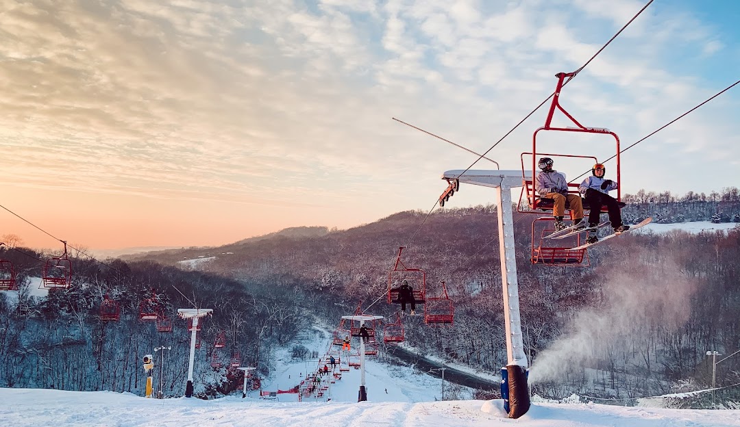 Sundown Mountain Resort in USA - a person riding a ski lift in the snow.