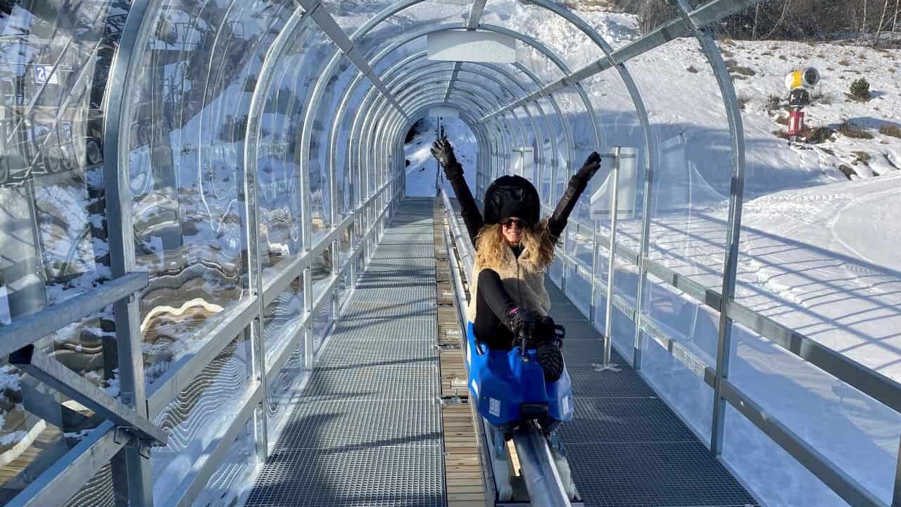 Les Angles in France - a woman standing on a bridge in the snow.
