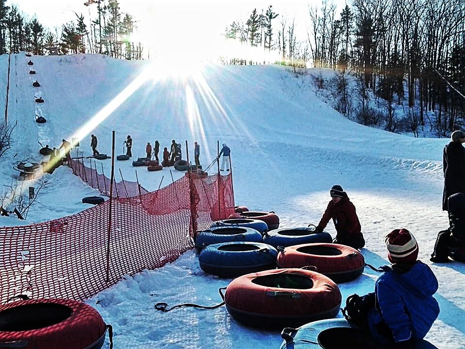 A winter sports scene at Mt Holiday in Michigan USA featuring a ski resort surrounded by snow-covered trees accentuating the vibe of the winter season.
