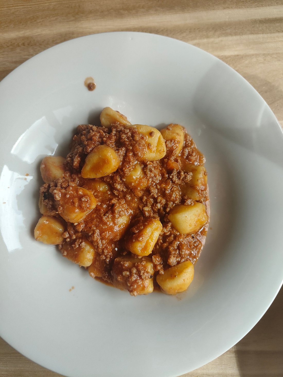 Pintura – Bolognola in Italy - a plate of food on a wooden table.