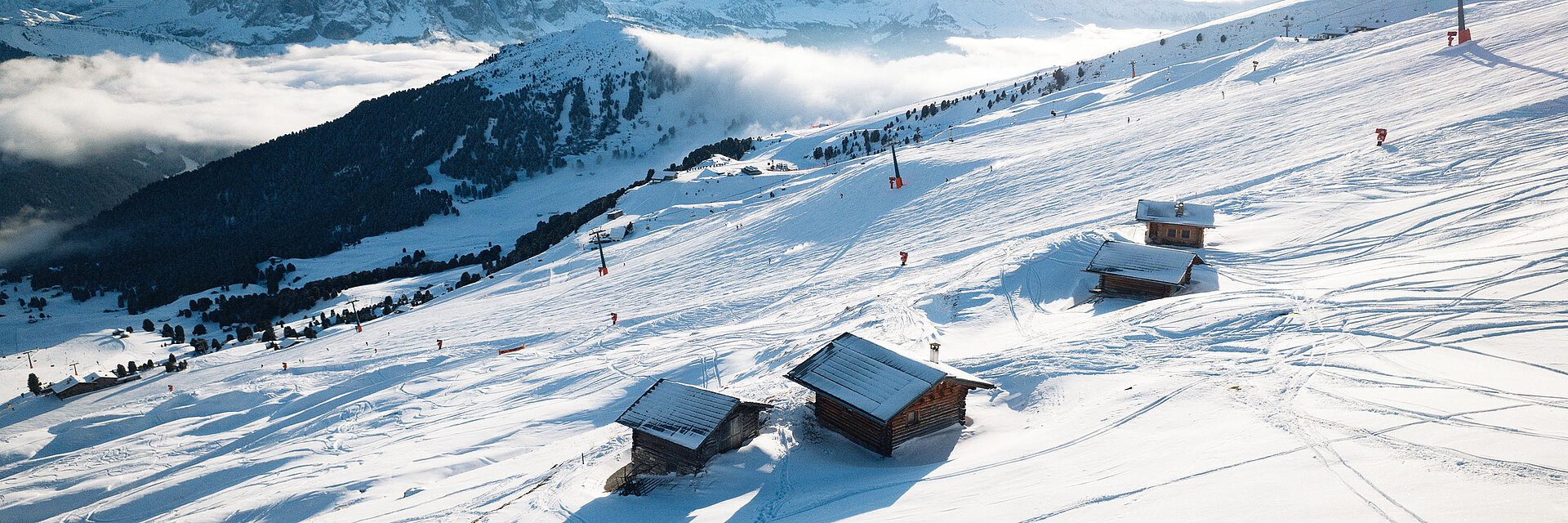 Plose – Brixen in Italy - a group of people skiing down a snowy mountain.