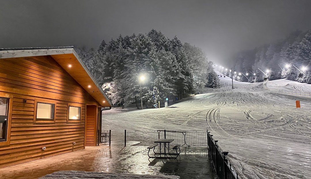 Winter sports enthusiasts enjoying a day at Woods Valley Ski Resort in Central New York, surrounded by stunning and serene snow-blanketed scenery.