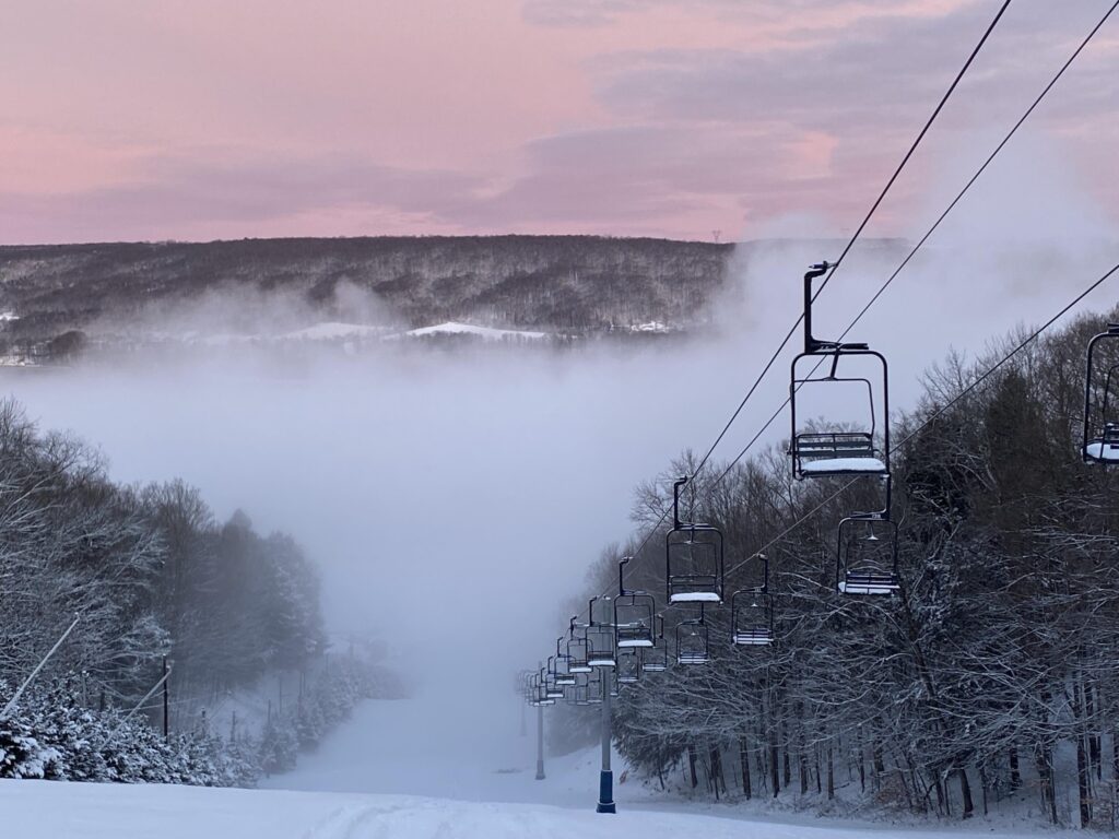Woods Valley in USA - a ski lift going up a snowy hill.