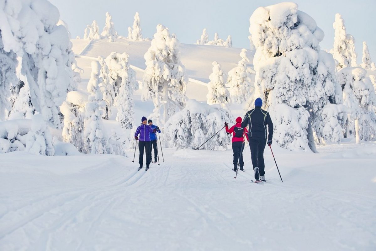 Luosto in Finland - two people cross country skiing in the snow.