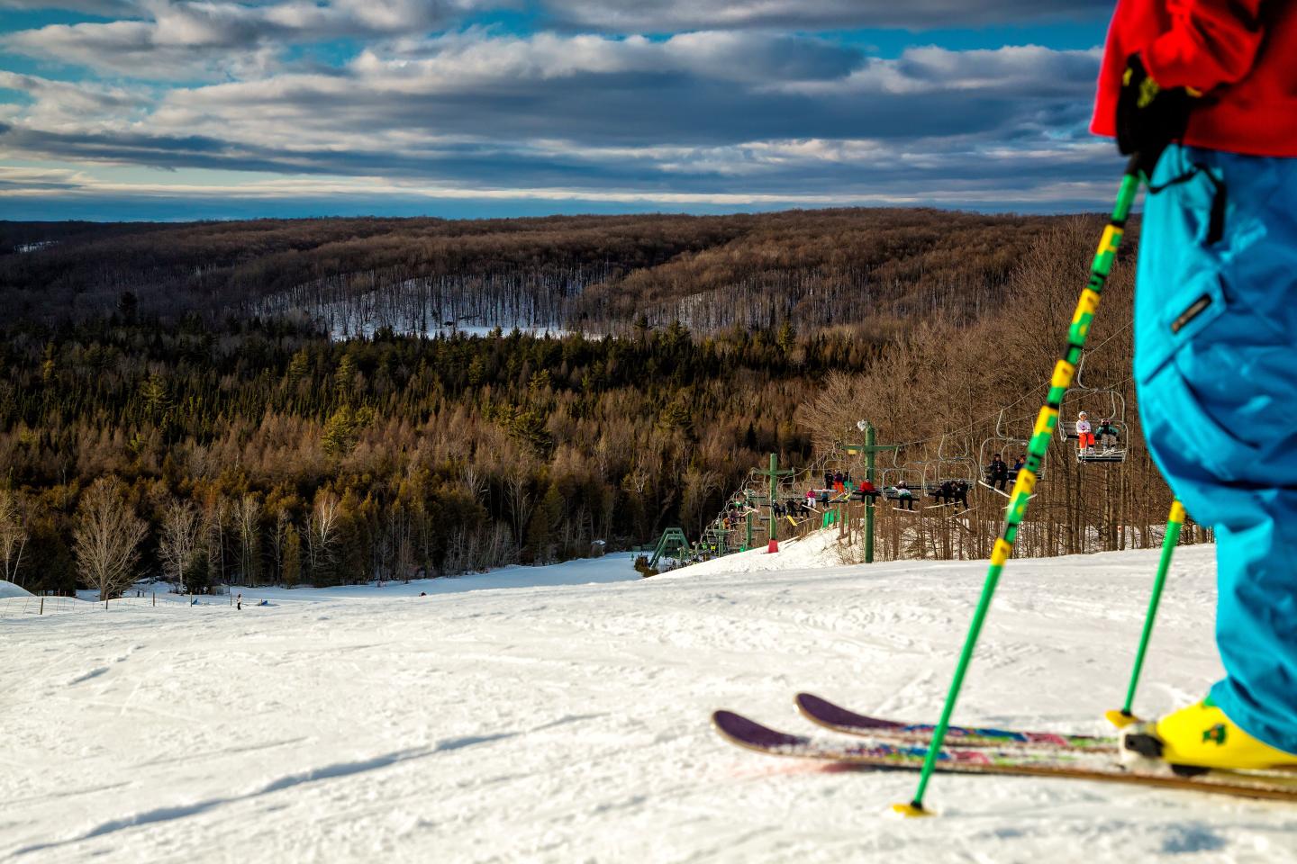 Treetops in USA - a person standing on top of a snow covered hill.
