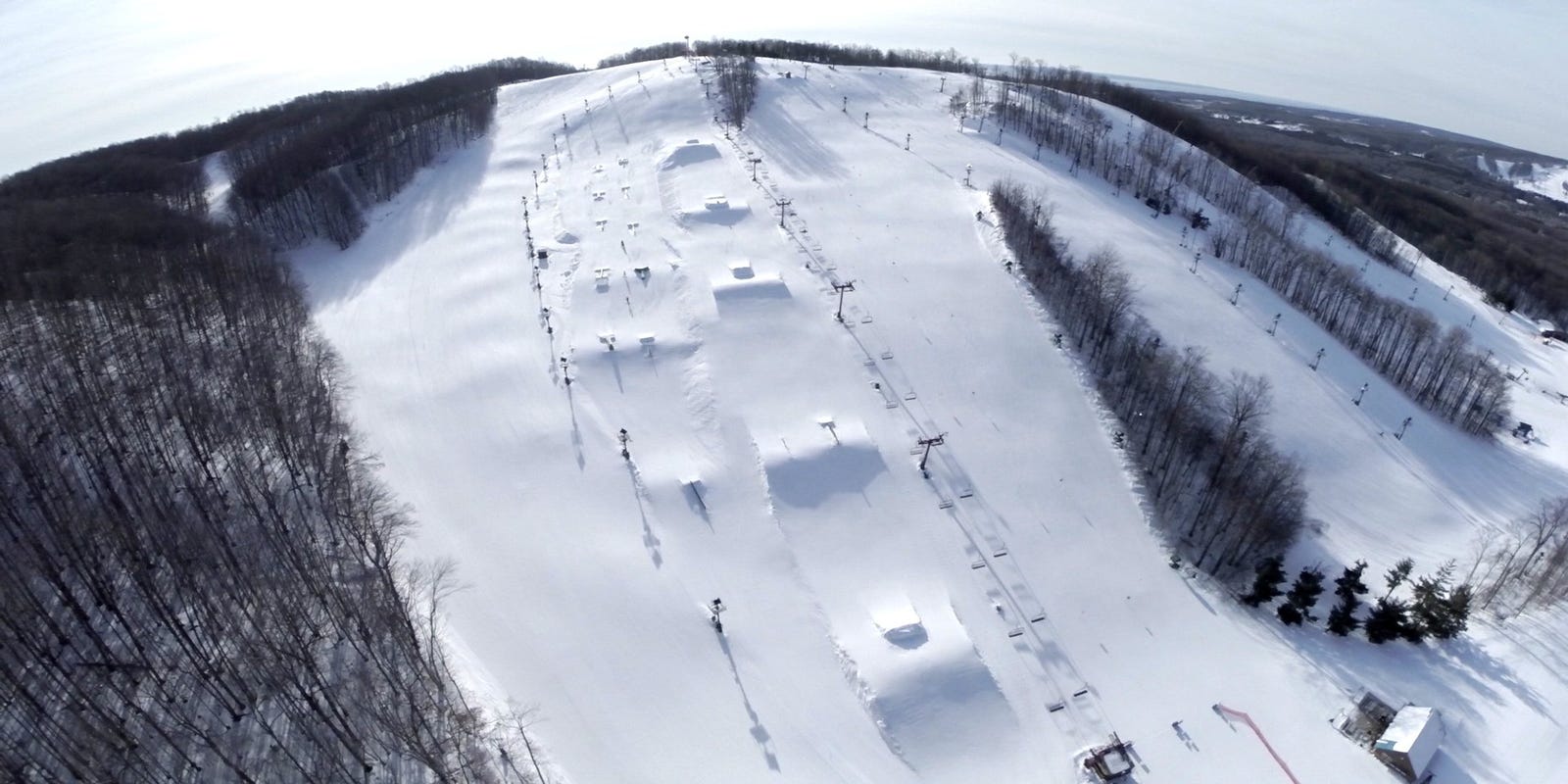 Treetops in USA - an aerial view of a snow covered ski slope.