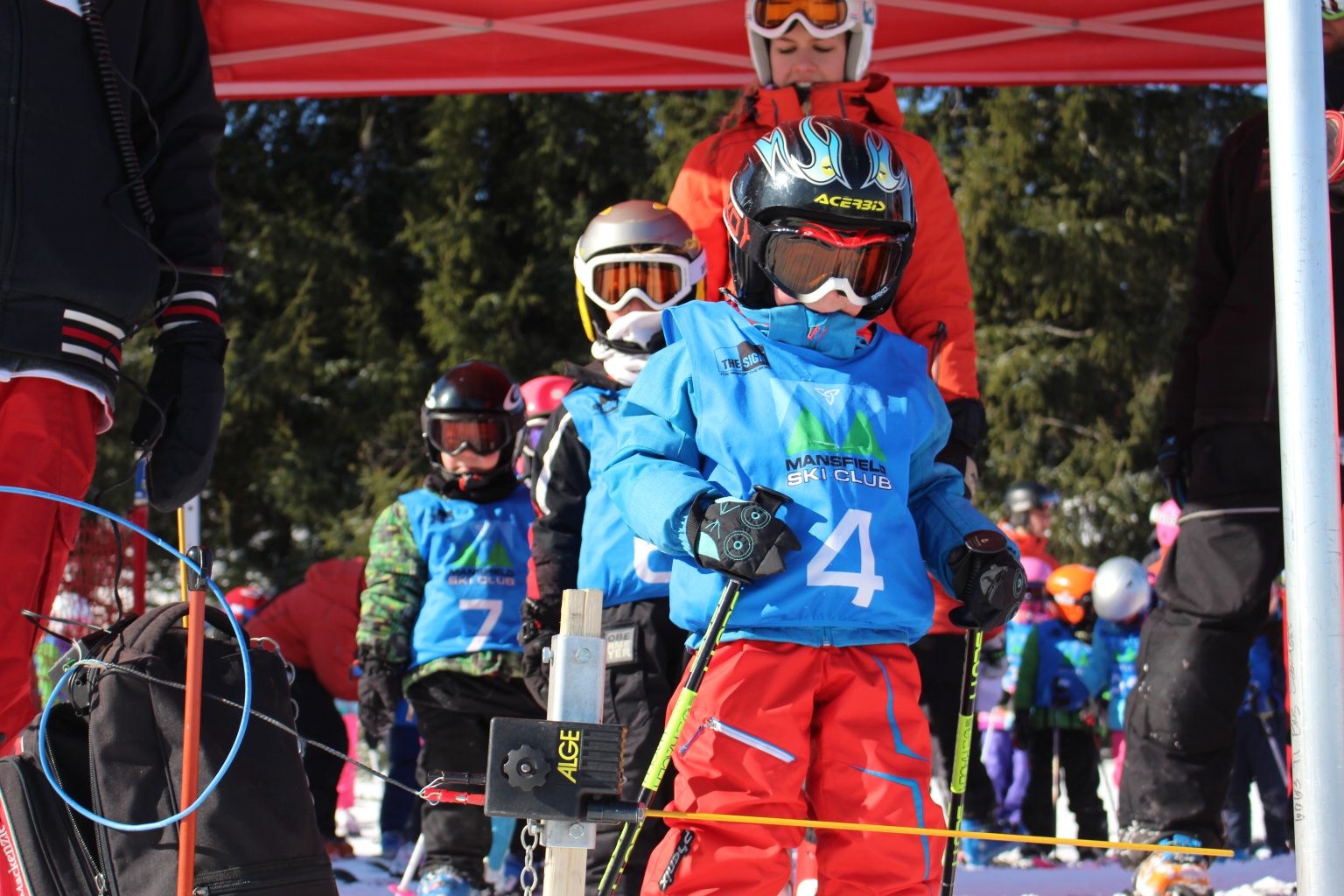 Mansfield Ski Club in Canada - a group of people standing on a ski slope.