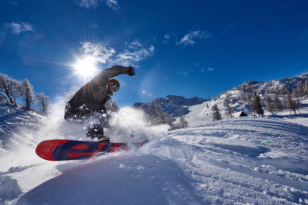 Marela – Kisovec in Slovenia - a person on a snowboard in the snow.