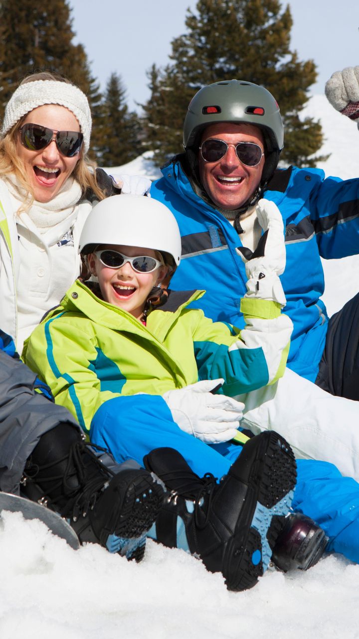 Meråker Alpinsenter in Norway - three people sitting in the snow.