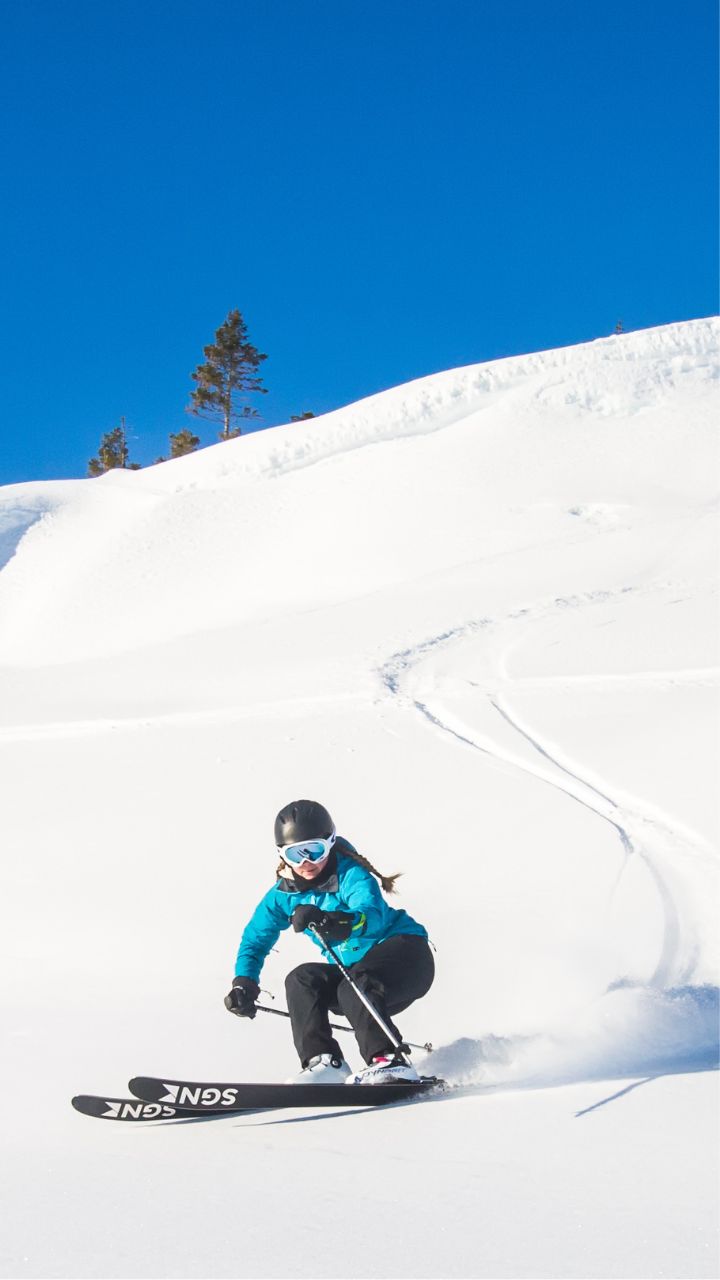 Meråker Alpinsenter in Norway - a person riding a snowboard down a snowy slope.