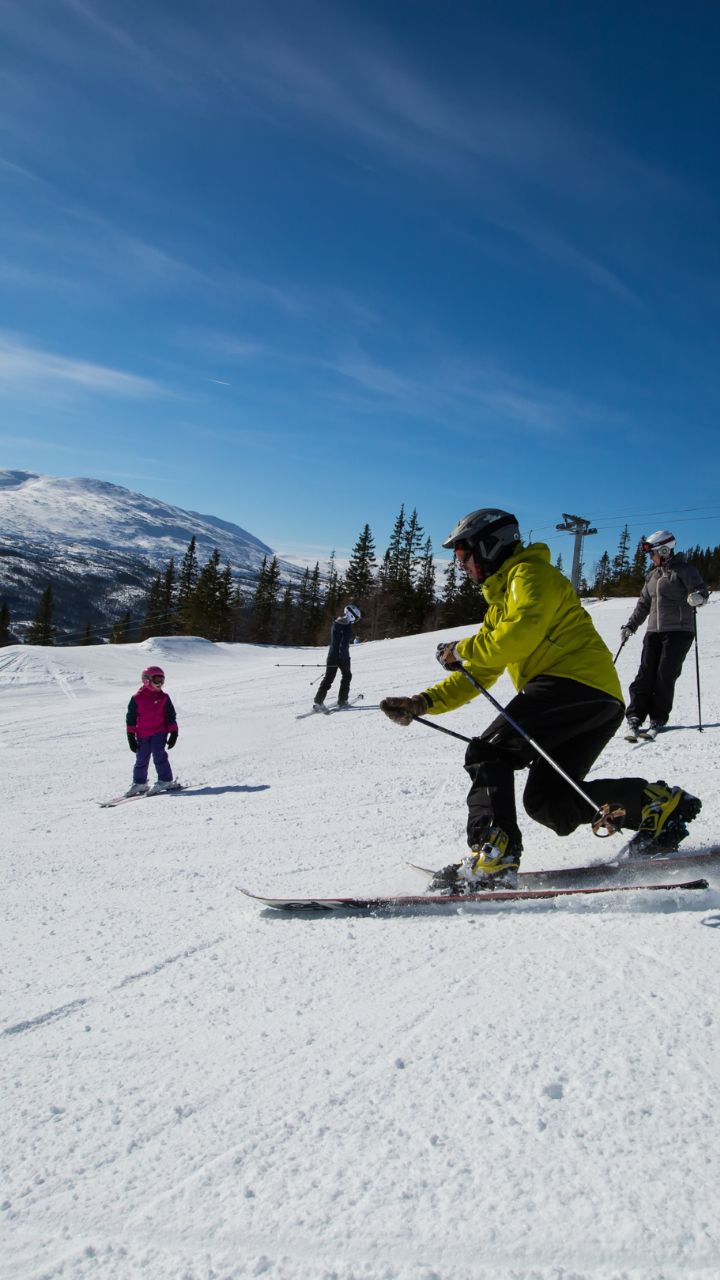 Meråker Alpinsenter in Norway - a group of people skiing down a mountain.