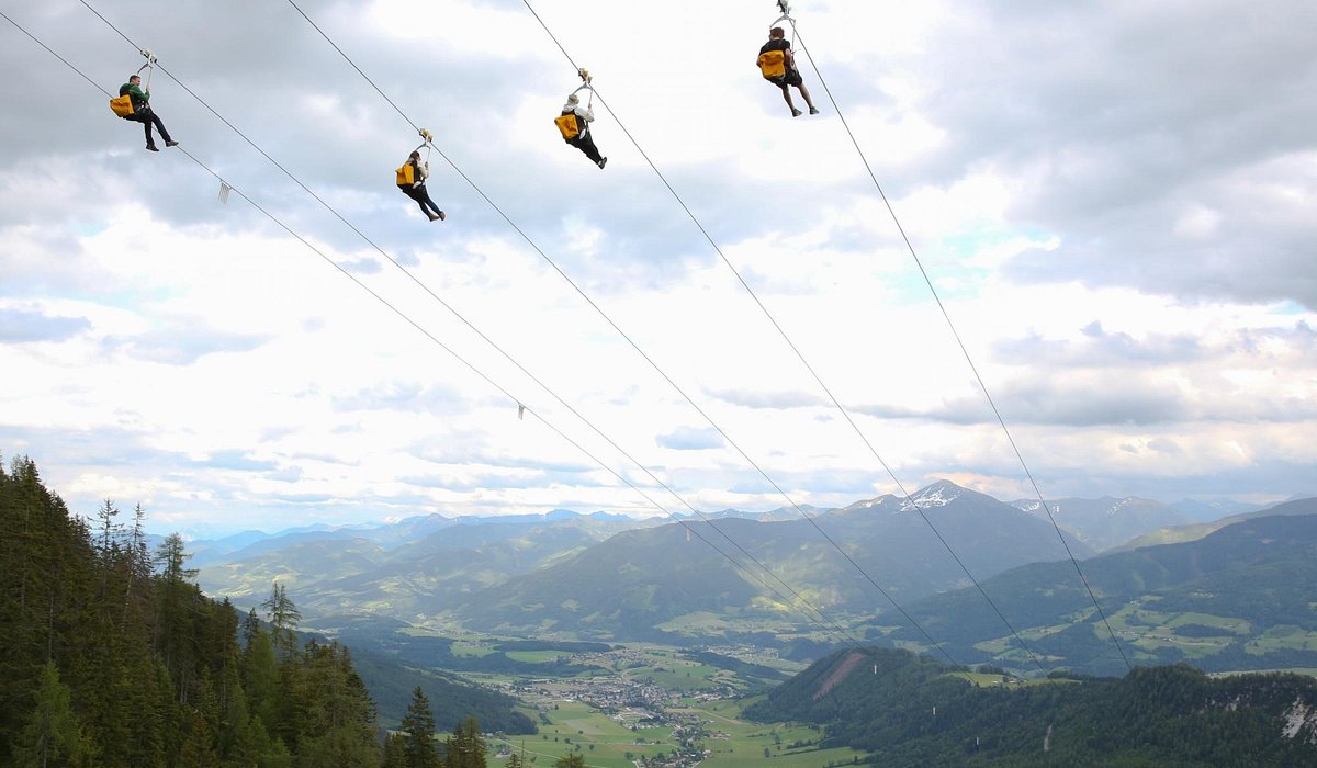 Stoderzinken – Gröbming in Austria - two people on a zip line in the mountains.