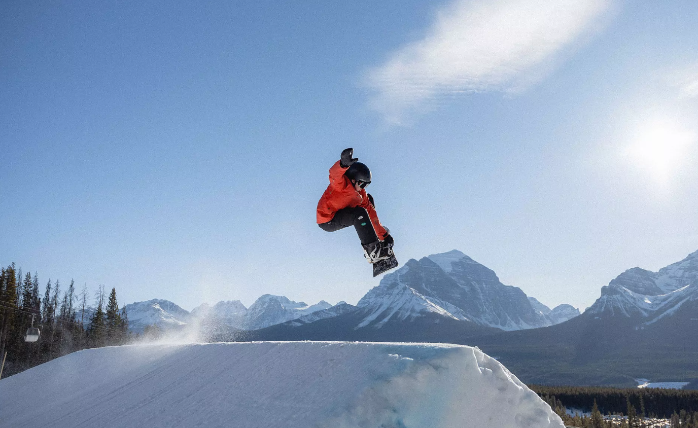 Pass Powderkeg – Crowsnest Pass in Canada - a person on a snowboard jumping off a ramp.